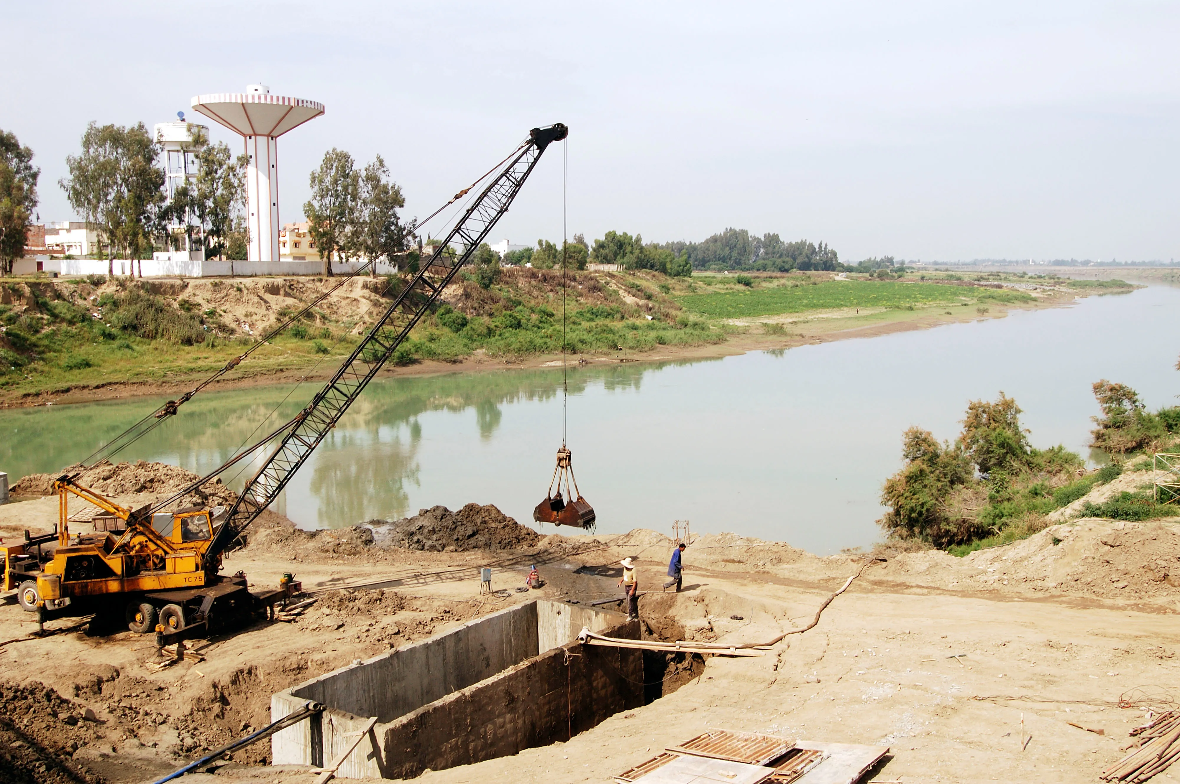 Aerial photo of a large shipping barge next to a concrete pier.